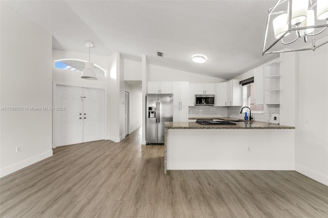 kitchen featuring lofted ceiling, dark stone countertops, white cabinets, stainless steel appliances, and open shelves