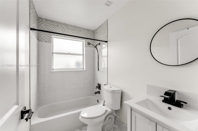 bathroom featuring toilet, vanity, and shower / tub combination