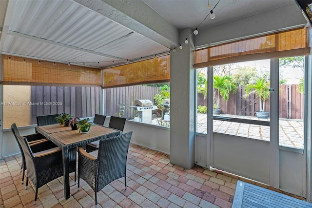 sunroom / solarium featuring outdoor dining area