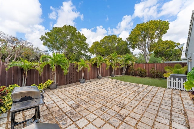 view of patio featuring cooling unit, area for grilling, and a fenced backyard