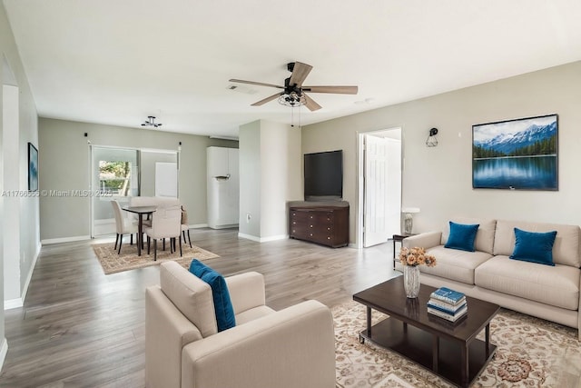 313 NW Dorchester St, Port St Lucie, FL 34983 - living room with a ceiling fan, baseboards, visible vents, and wood finished floors