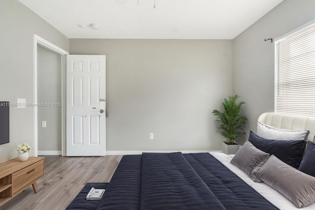 313 NW Dorchester St, Port St Lucie, FL 34983 - bedroom featuring baseboards and light wood-style floors