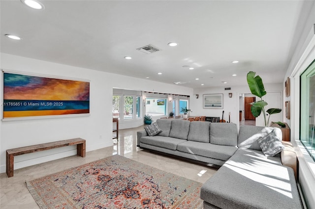 living area with visible vents, recessed lighting, marble finish floor, and baseboards