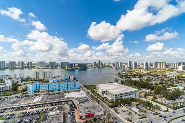 birds eye view of property featuring a view of city and a water view