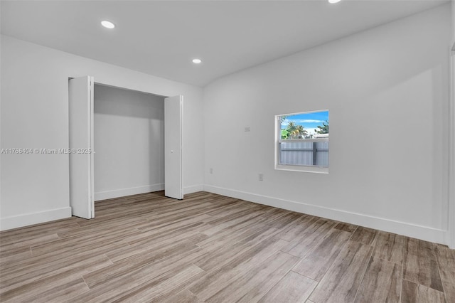 unfurnished bedroom with recessed lighting, baseboards, and light wood-style flooring