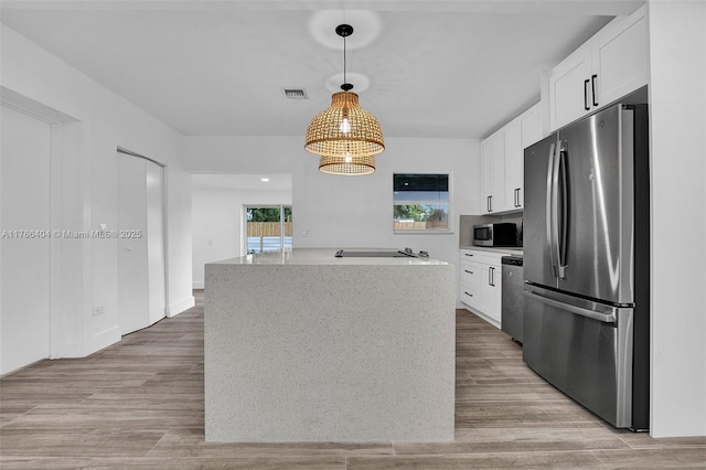 kitchen featuring white cabinets, light wood-style floors, visible vents, and appliances with stainless steel finishes