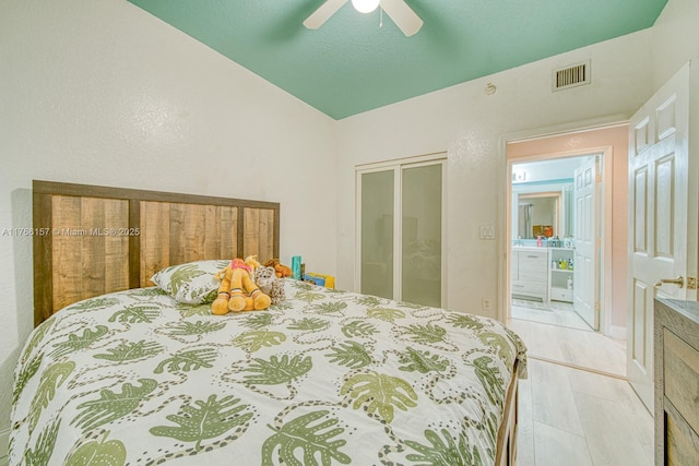 bedroom featuring a closet, visible vents, ceiling fan, and lofted ceiling