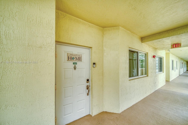 entrance to property with stucco siding