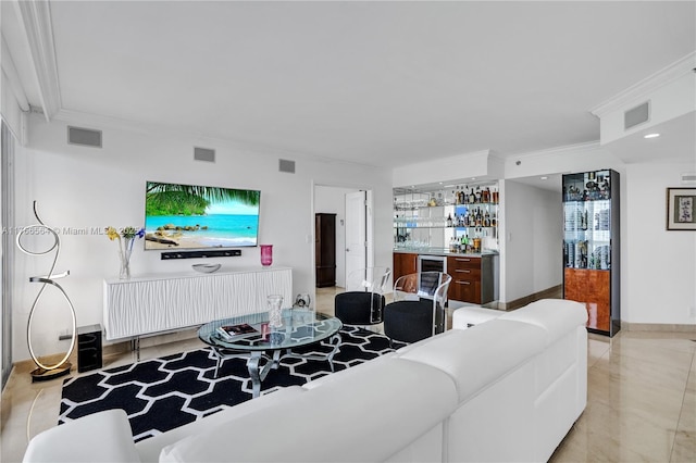 living room featuring indoor wet bar, visible vents, and ornamental molding