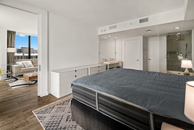 bedroom featuring wood finished floors and visible vents