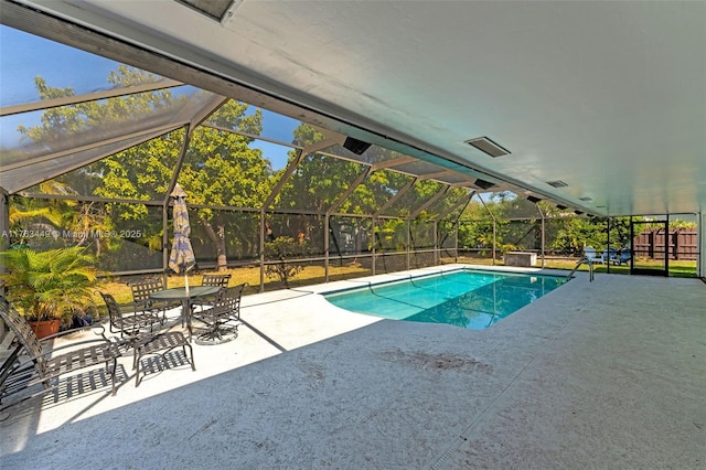 outdoor pool with a patio area and a lanai