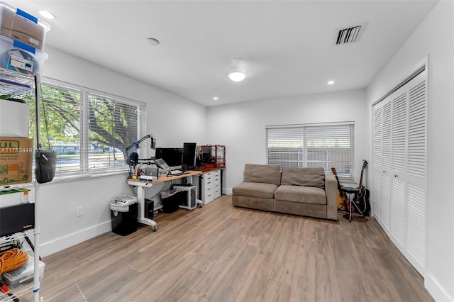 office featuring wood finished floors, baseboards, visible vents, and recessed lighting