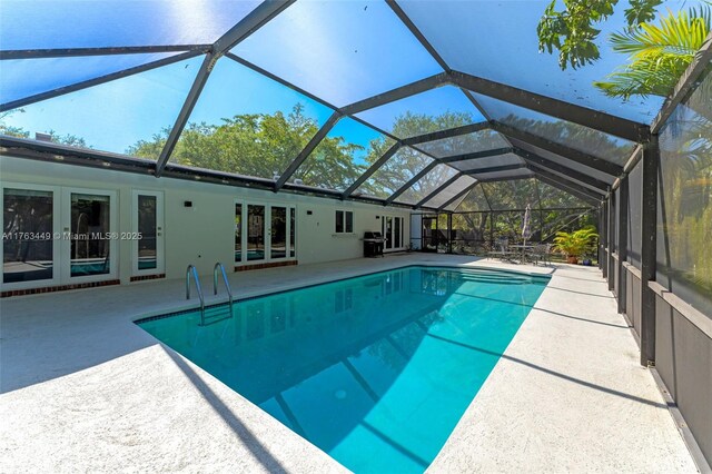 17554 SW 85th Ave, Palmetto Bay, FL 33157 - swimming pool with french doors, a patio, a grill, and a lanai