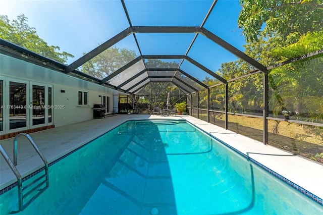 pool with a patio, grilling area, and french doors