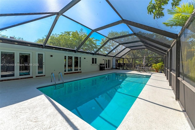 pool with a patio area, french doors, and grilling area