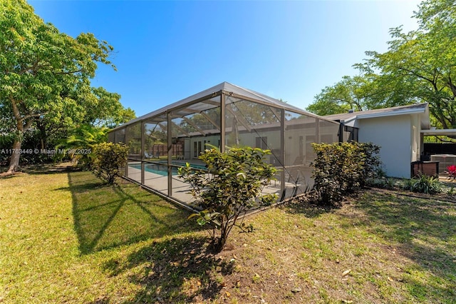 view of yard with an outdoor pool, a patio, and glass enclosure
