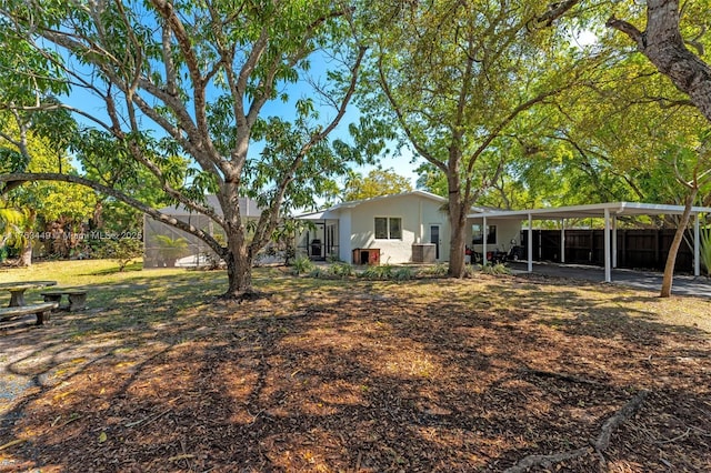 view of yard featuring a carport and fence