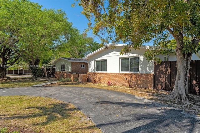 view of front of home with fence and brick siding