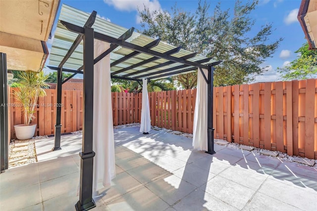 view of patio / terrace with a pergola and a fenced backyard