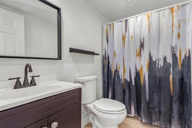 bathroom with tile patterned floors, toilet, vanity, and a shower with curtain