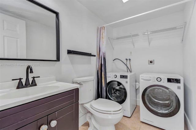 full bath featuring washer and dryer, toilet, vanity, and tile patterned flooring