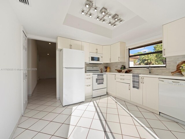 13481 SW 103rd St, Miami, FL 33186 - kitchen featuring tasteful backsplash, a raised ceiling, white appliances, and light countertops