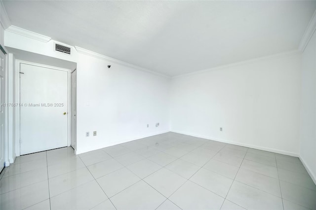 unfurnished room with visible vents, baseboards, ornamental molding, and light tile patterned flooring