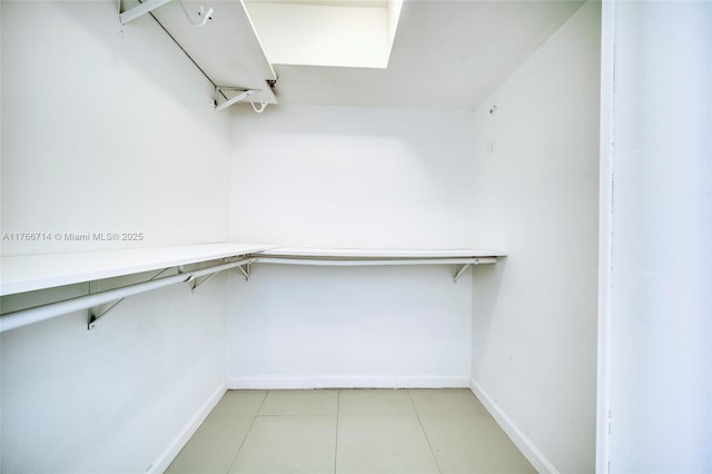 spacious closet with light tile patterned floors