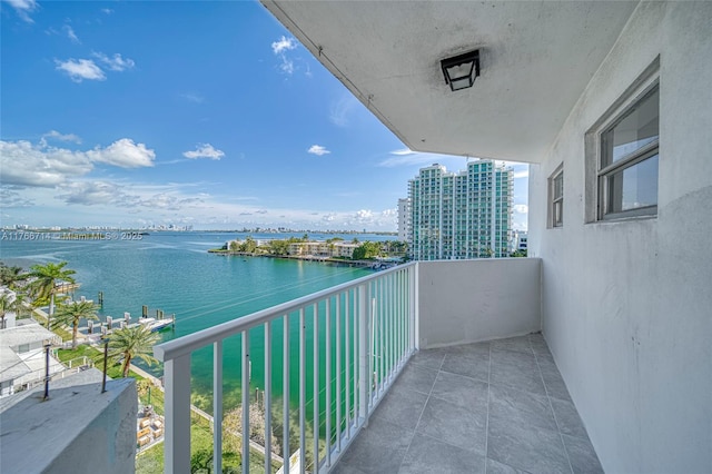 balcony featuring a water view and a city view