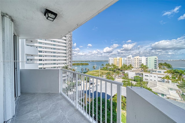 balcony with a view of city and a water view