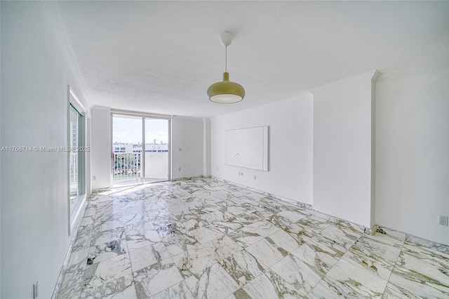 spare room featuring marble finish floor and ornamental molding