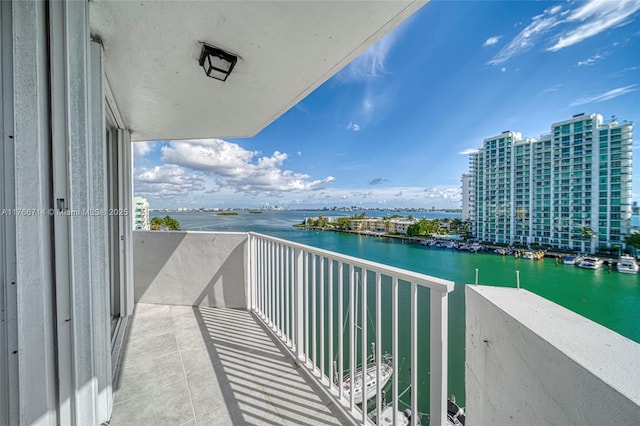 balcony featuring a view of city and a water view