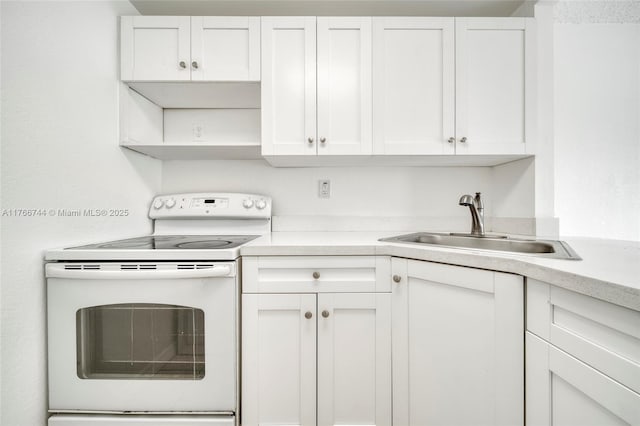 kitchen featuring a sink, white cabinets, white electric range oven, and light countertops