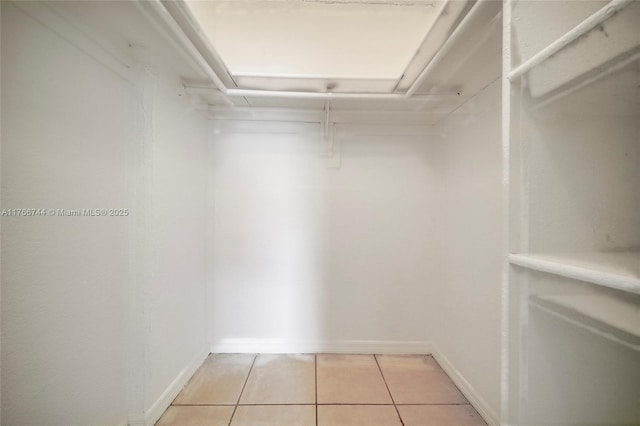 spacious closet featuring light tile patterned floors
