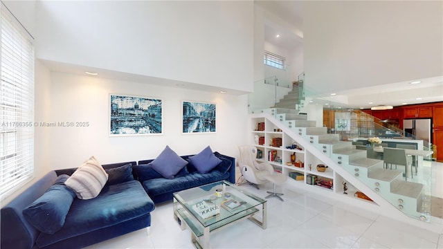 living area featuring a high ceiling, tile patterned floors, stairway, and recessed lighting