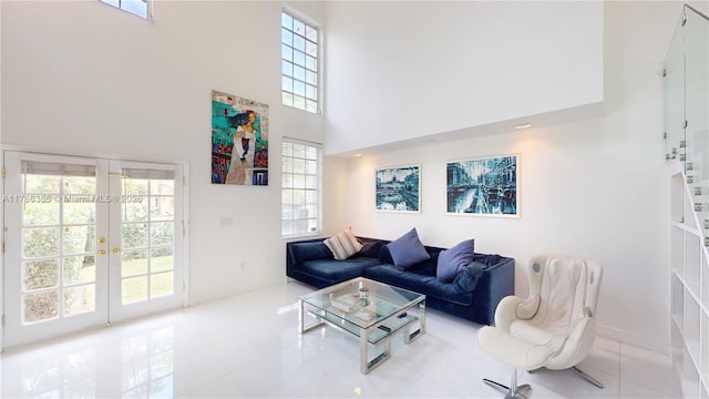 living room with a high ceiling, tile patterned flooring, and french doors