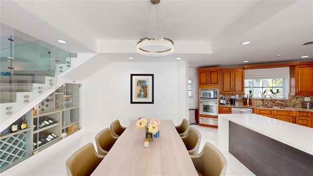 dining room with a tray ceiling and recessed lighting