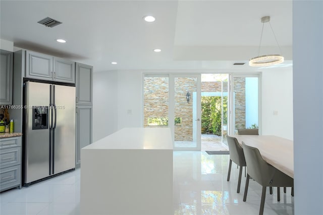kitchen with visible vents, stainless steel fridge, recessed lighting, gray cabinetry, and pendant lighting
