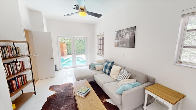 living area featuring visible vents, ceiling fan, and french doors