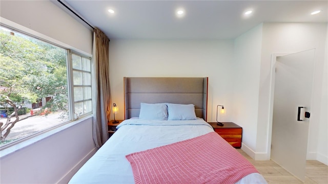 bedroom featuring baseboards, light wood finished floors, and recessed lighting