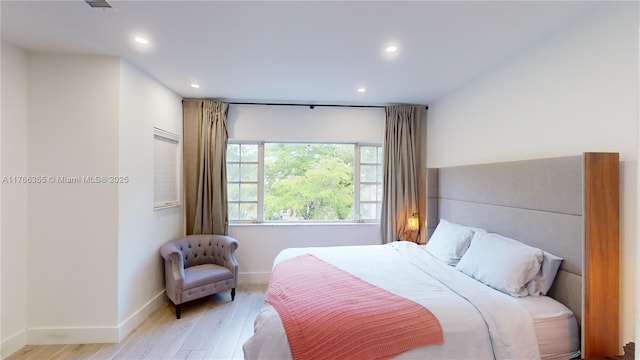 bedroom featuring recessed lighting, baseboards, and wood finished floors