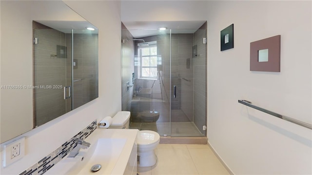 bathroom featuring tile patterned flooring, vanity, toilet, baseboards, and a shower stall