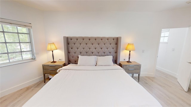 bedroom featuring baseboards and light wood-style floors