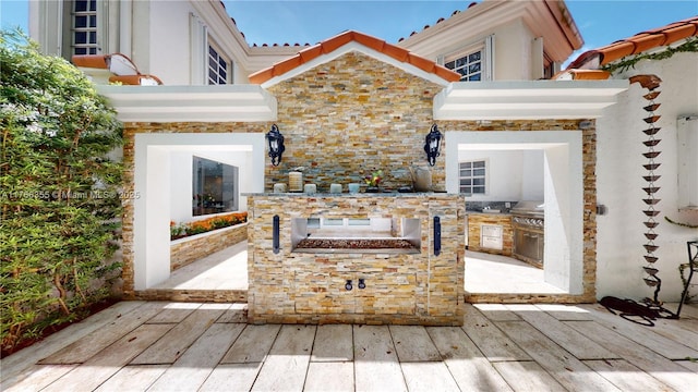 view of patio featuring a wooden deck and area for grilling