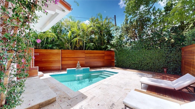 view of swimming pool with a fenced backyard and a patio area