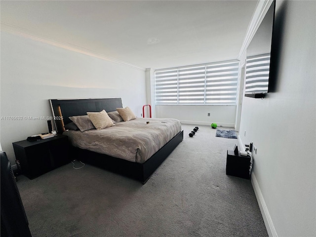 bedroom with baseboards, crown molding, and carpet