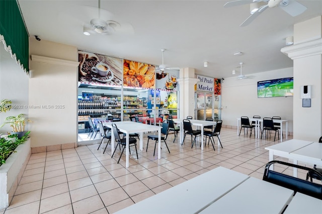 dining space with light tile patterned flooring and a ceiling fan
