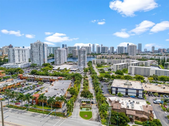 birds eye view of property featuring a water view and a city view