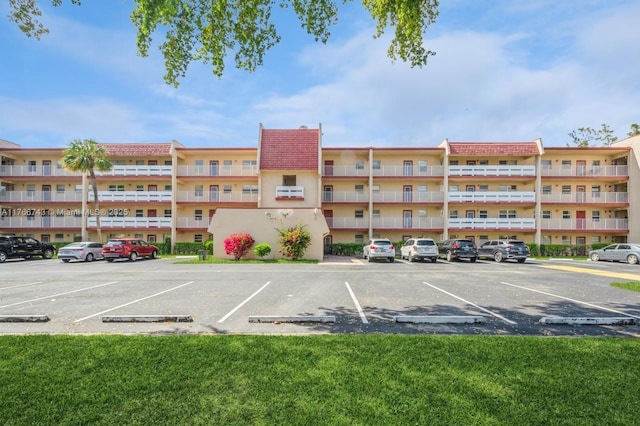 view of building exterior featuring uncovered parking