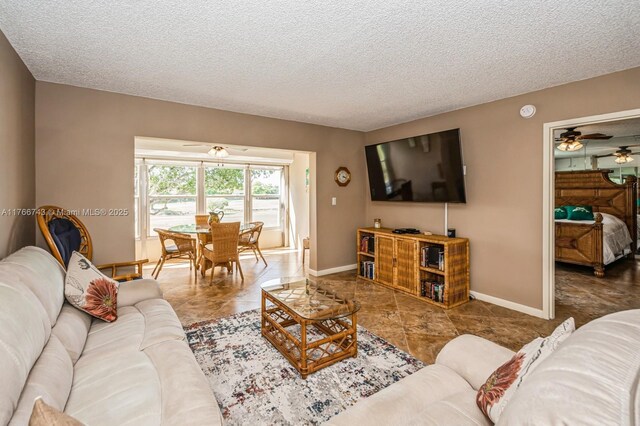 1045 Country Club Dr Unit 304, Margate, FL 33063 - living room with baseboards, a textured ceiling, and a ceiling fan